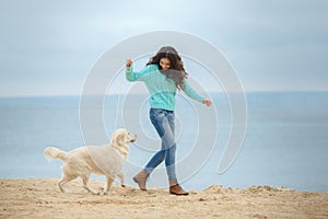 Beautiful girl with her dog near sea