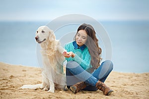 Beautiful girl with her dog near sea