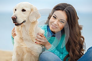 Beautiful girl with her dog near sea