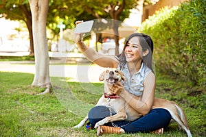 Beautiful girl and her dog taking a selfie