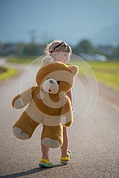 Beautiful girl and her teddy bear