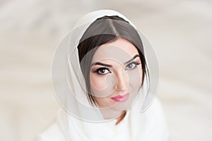 Beautiful girl in hijab looks into the camera