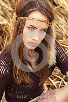 Beautiful girl hippies sitting in the dry grass