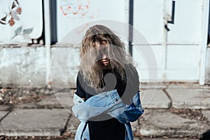 Beautiful girl hipster against the wall