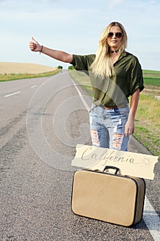 Beautiful Girl Hitchhiking On The Road Traveling