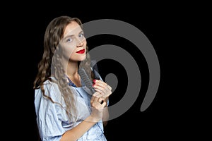 Beautiful girl holding black combs