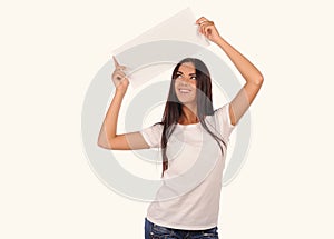 Beautiful girl holding a blank billboard