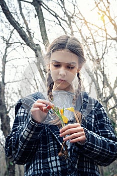 Beautiful girl holding a bouquet of yellow crocuses