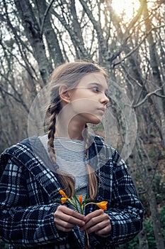 Beautiful girl holding a bouquet of yellow crocuses