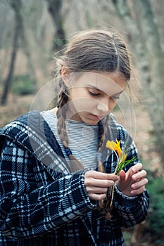 Beautiful girl holding a bouquet of yellow crocuses