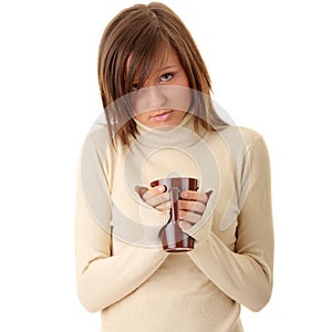 A beautiful girl holding a cup of hot drink