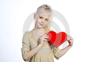 Beautiful girl holding heart in arms