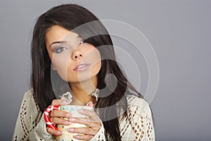 Beautiful girl holding hot tea cup