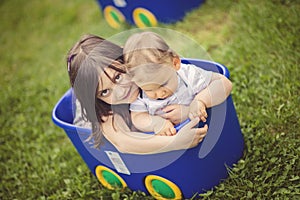 Beautiful girl holding and hugging her brother