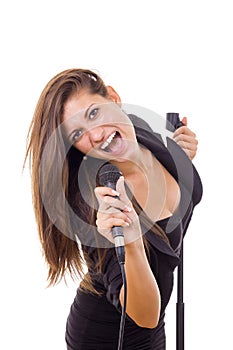 beautiful girl holding microphone and singing loud in black dress