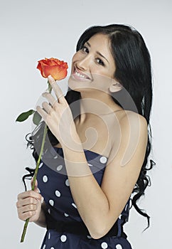 Beautiful girl holding a rose