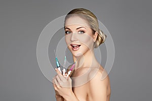 Beautiful girl holding syringes