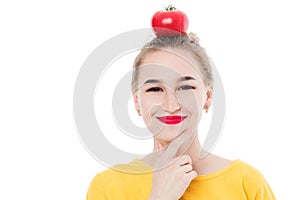 Beautiful girl holding a tomato in her hands, on a white isolated background. The concept of a healthy diet and diet.