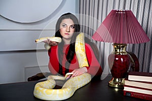 Beautiful girl holding a white albino python