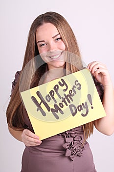 Beautiful girl holds a table with the words Happy mothers day