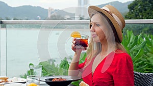 A beautiful girl on holiday vacation indulges in a delicious dinner