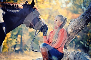 Beautiful girl with horse in autumn forest