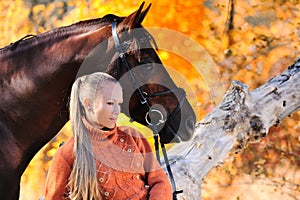 Beautiful girl with horse in autumn forest