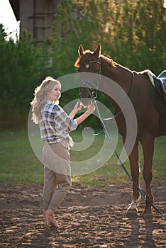 Beautiful girl and a horse. Chestnut horse together with her favorite owner young teenage girl.