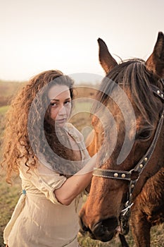 Beautiful girl with a horse outdoors