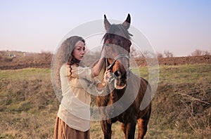 Beautiful girl with a horse outdoors