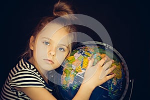 Beautiful girl hugging a globe