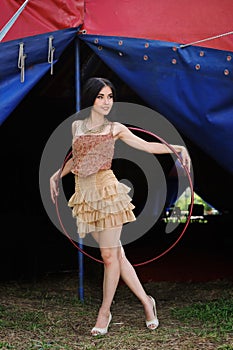 Beautiful girl with hula hoop in designer dress