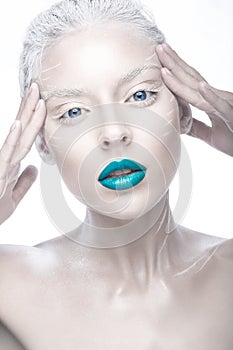 Beautiful girl in the image of albino with blue lips and white eyes. Art beauty face.