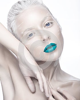 Beautiful girl in the image of albino with blue lips and white eyes. Art beauty face.