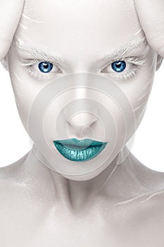 Beautiful girl in the image of albino with blue lips and white eyes. Art beauty face.