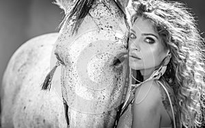 Beautiful girl interacting and having fun with a horse at the ranch