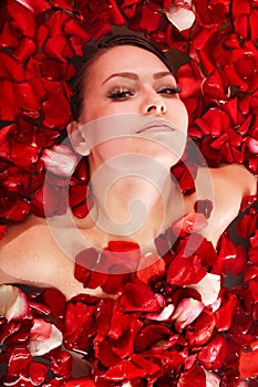 Beautiful girl in jacuzzi with rose petal.