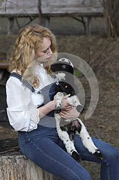 Beautiful girl with lamb in her arms