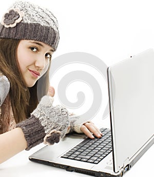 Beautiful girl with a laptop, showing thumb up.