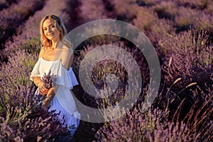Beautiful girl on the lavender field. Beautiful woman in the lavender field on sunset