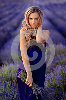 Beautiful girl on the lavender field. Beautiful woman in the lavender field on sunset