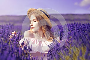 Beautiful girl on the lavender field. Beautiful woman in the lavender field on sunset. Soft focus. Provence, France. A girl in pin