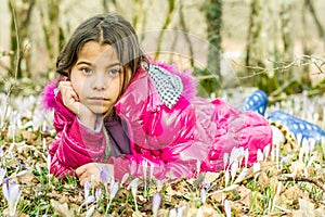 Beautiful girl laying in the flowers in the forest