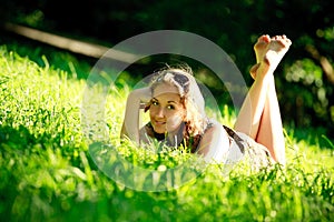 Beautiful girl laying on sunny meadow