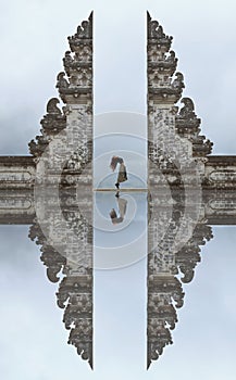 Beautiful Girl Levitating Near Gates Of Heaven In Pura Lempuyang Temple In Bali, Indonesia.