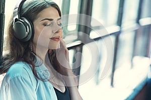 Beautiful girl listening to music on headphones