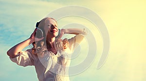 Beautiful girl listening to music on headphones