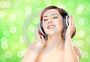 Beautiful girl listening to the music in headphones