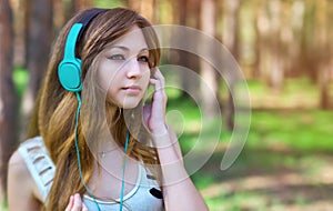 Beautiful girl listening to music with headphones