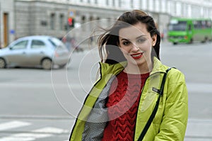 Beautiful girl with long brown hair walks around the city